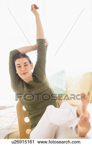 Woman with feet up and raised arms View Large Photo Image Stock Image - Woman with feet up and raised arms. Fotosearch