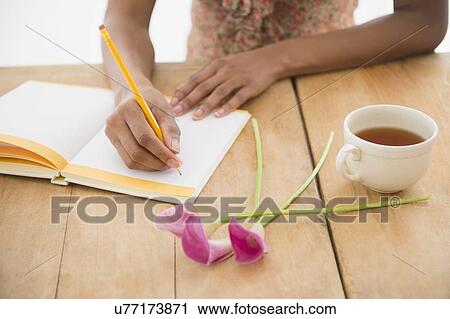 Stock Image - Woman writing diary. Fotosearch