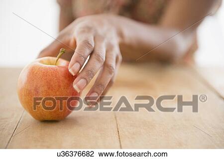 Woman's hand reaching for apple View Large Photo Image Stock Image - Woman's hand reaching for apple. Fotosearch