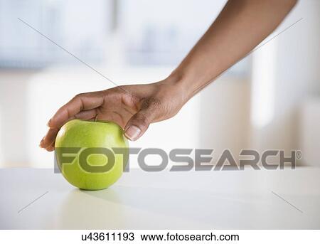 Woman's hand reaching for apple View Large Photo Image Stock Image - Woman's hand reaching for apple. Fotosearch