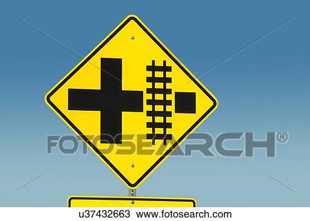 Stock Image - Yellow road sign depicting railroad crossing. Fotosearch