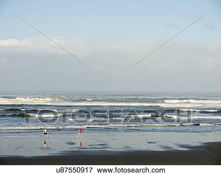 Young adult men running on beach View Large Photo Image Stock Photo - Young adult men running on beach. Fotosearch