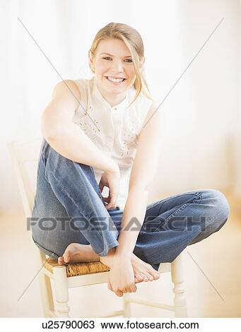 Young cheerful woman sitting on chair View Large Photo Image Stock Image - Young cheerful woman sitting on chair. Fotosearch