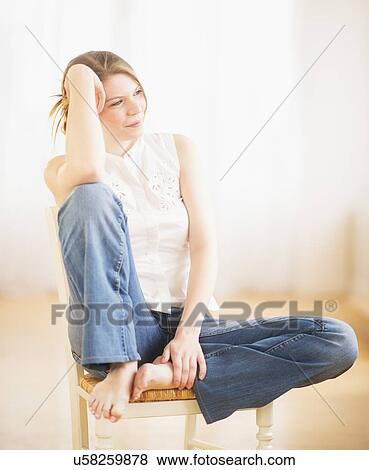Young cheerful woman sitting on chair View Large Photo Image Stock Photo - Young cheerful woman sitting on chair. Fotosearch