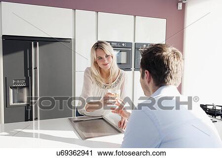 Young couple in kitchen View Large Photo Image Stock Image - Young couple in kitchen. Fotosearch