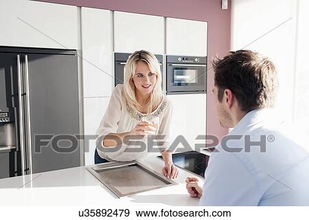 Young couple in kitchen View Large Photo Image Stock Photo - Young couple in kitchen. Fotosearch