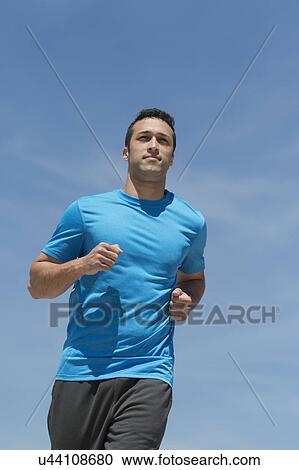 Stock Image - Young man running. Fotosearch