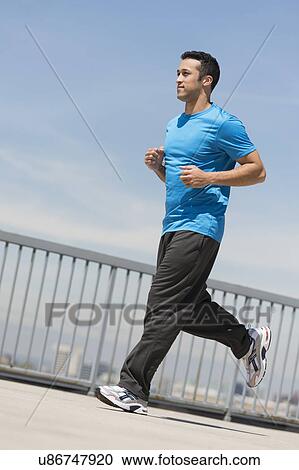 Stock Image - Young man running. Fotosearch