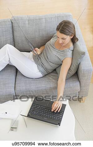 Young woman doing home finances View Large Photo Image Picture - Young woman doing home finances. Fotosearch