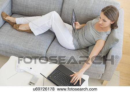 Young woman doing home finances View Large Photo Image Stock Photo - Young woman doing home finances. Fotosearch