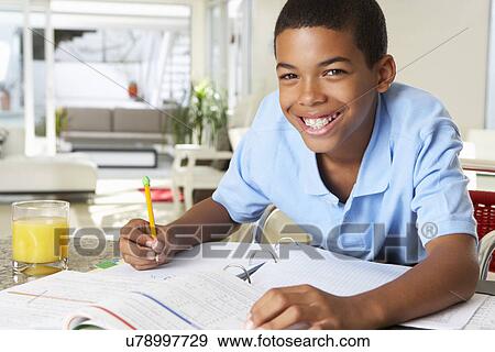 Boy Doing Homework In Kitchen View Large Photo Image Stock Photo - Boy Doing Homework In Kitchen. Fotosearch