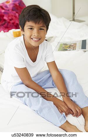 Boy Lying On Bed In Pajamas Together View Large Photo Image Stock Photo - Boy Lying On Bed In Pajamas Together. Fotosearch