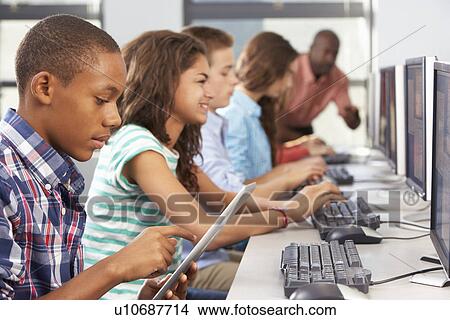 Boy Using Digital Tablet In Computer Class View Large Photo Image Picture - Boy Using Digital Tablet In Computer Class. Fotosearch