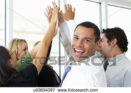 Business Team Giving One Another High Five View Large Photo Image Stock Photo - Business Team Giving One Another High Five. Fotosearch