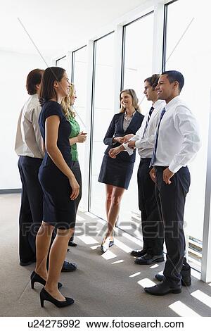 Stock Image - Business Team Having Informal Meeting In Office. Fotosearch