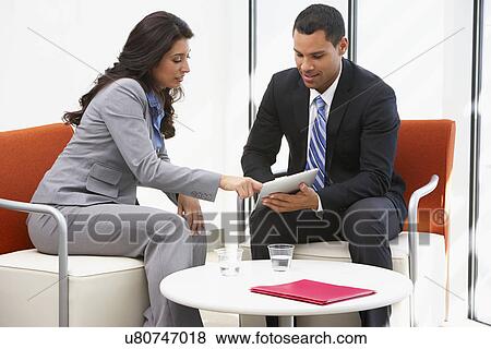 Businessman And Businesswoman Having Informal Office Meeting View Large Photo Image Stock Photo - Businessman And Businesswoman Having Informal Office Meeting. Fotosearch