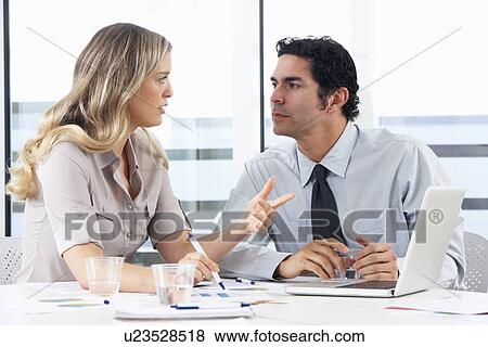 Stock Photo - Businessman And Businesswoman Meeting In Office. Fotosearch