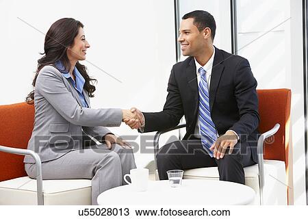 Stock Image - Businessman And Businesswoman Shaking Hands After Meeting. Fotosearch