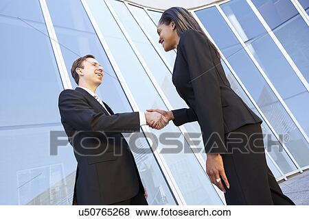 Businessman And Businesswomen Shaking Hands Outside Office View Large Photo Image Stock Photo - Businessman And Businesswomen Shaking Hands Outside Office. Fotosearch