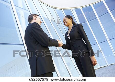 Businessman And Businesswomen Shaking Hands Outside Office View Large Photo Image Stock Photo - Businessman And Businesswomen Shaking Hands Outside Office. Fotosearch