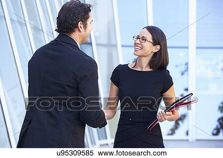 Stock Photography - Businessman And Businesswomen Shaking Hands Outside Office. Fotosearch