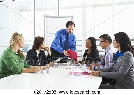 Businessman Conducting Meeting In Boardroom View Large Photo Image Stock Photograph - Businessman Conducting Meeting In Boardroom. Fotosearch