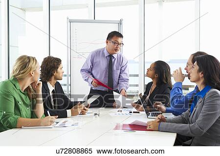 Businessman Conducting Meeting In Boardroom View Large Photo Image Stock Photography - Businessman Conducting Meeting In Boardroom. Fotosearch