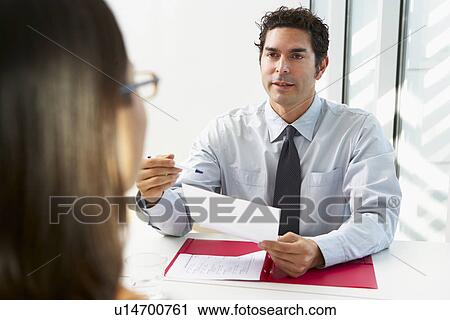 Stock Image - Businessman Interviewing Female Candidate For Job. Fotosearch