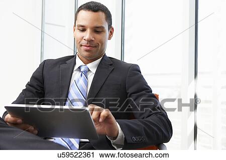 Businessman Using Digital Tablet In Office View Large Photo Image Stock Image - Businessman Using Digital Tablet In Office. Fotosearch