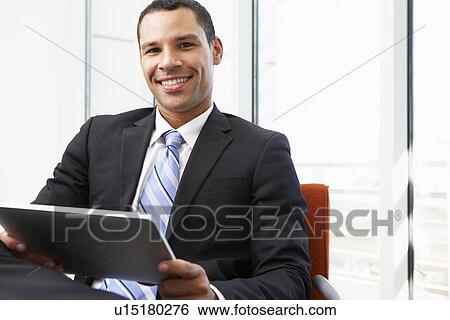 Businessman Using Digital Tablet In Office View Large Photo Image Stock Photograph - Businessman Using Digital Tablet In Office. Fotosearch