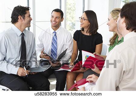 Stock Photography - Businesspeople Having Informal Office Meeting. Fotosearch