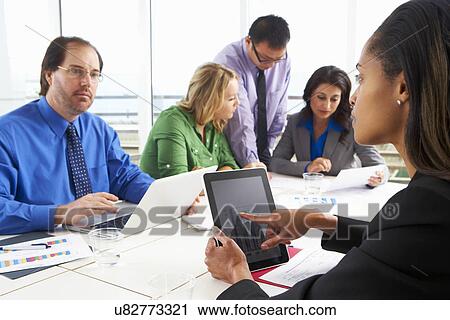 Stock Image - Businesspeople Meeting In Boardroom. Fotosearch