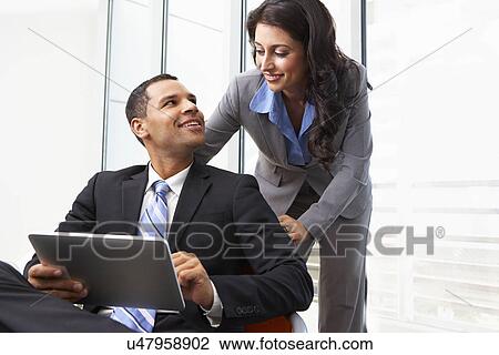 Businesspeople With Digital Tablet During Informal Meeting View Large Photo Image Stock Image - Businesspeople With Digital Tablet During Informal Meeting. Fotosearch