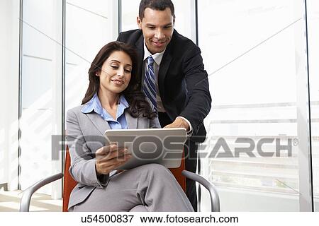 Businesspeople With Digital Tablet During Informal Meeting View Large Photo Image Stock Photo - Businesspeople With Digital Tablet During Informal Meeting. Fotosearch