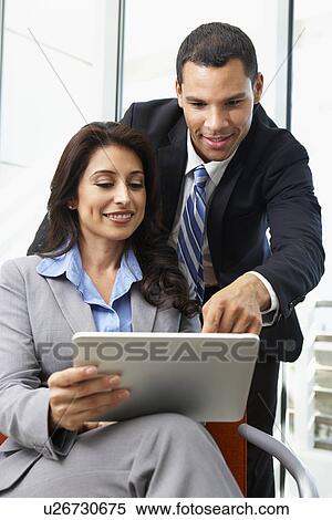 Businesspeople With Digital Tablet During Informal Meeting View Large Photo Image Stock Photography - Businesspeople With Digital Tablet During Informal Meeting. Fotosearch