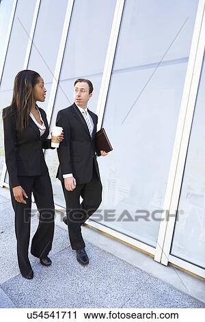 Stock Image - Businesspeople With Takeaway Coffee Outside Office. Fotosearch