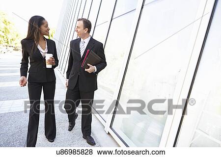 Stock Photo - Businesspeople With Takeaway Coffee Outside Office. Fotosearch