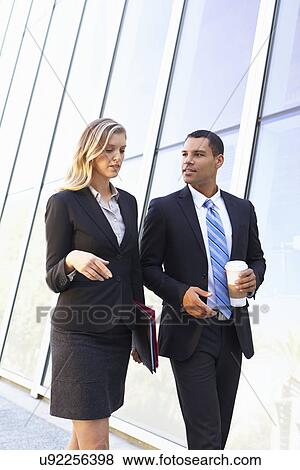 Stock Photo - Businesspeople With Takeaway Coffee Outside Office. Fotosearch