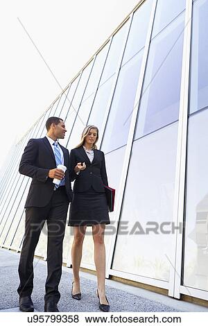 Stock Photo - Businesspeople With Takeaway Coffee Outside Office. Fotosearch
