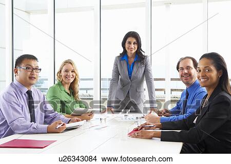 Businesswoman Conducting Meeting In Boardroom View Large Photo Image Picture - Businesswoman Conducting Meeting In Boardroom. Fotosearch