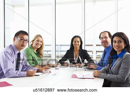 Stock Photo - Businesswoman Conducting Meeting In Boardroom. Fotosearch