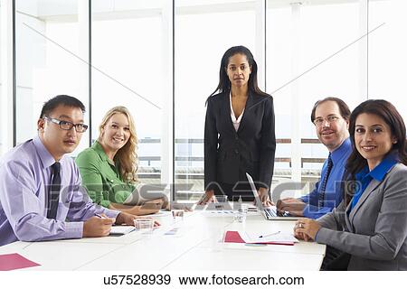 Businesswoman Conducting Meeting In Boardroom View Large Photo Image Stock Photo - Businesswoman Conducting Meeting In Boardroom. Fotosearch