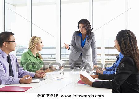 Businesswoman Conducting Meeting In Boardroom View Large Photo Image Stock Photo - Businesswoman Conducting Meeting In Boardroom. Fotosearch