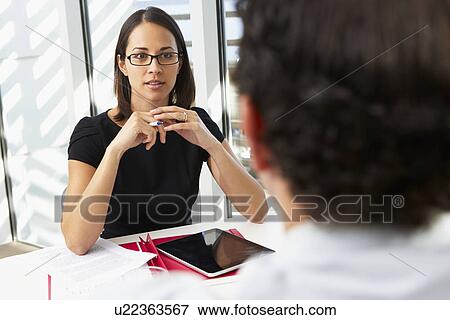 Stock Photo - Businesswoman Interviewing Male Candidate For Job. Fotosearch