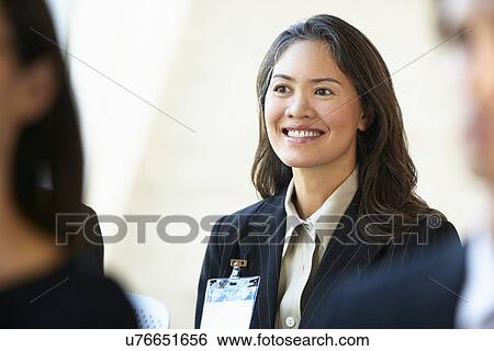 Stock Photograph - Businesswoman Listening To Speaker At Conference. Fotosearch