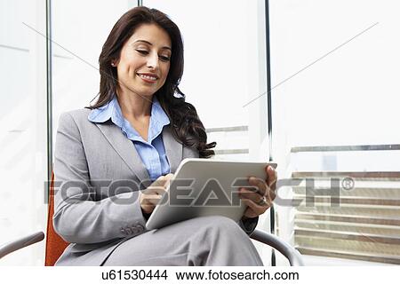 Picture - Businesswoman Using Digital Tablet In Office. Fotosearch