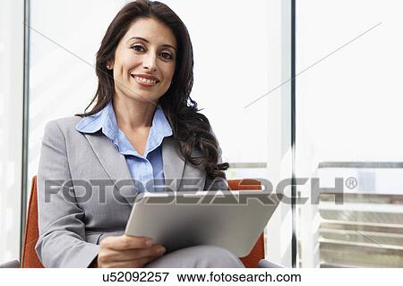 Stock Photo - Businesswoman Using Digital Tablet In Office. Fotosearch