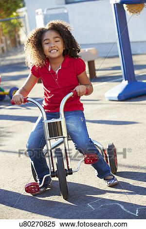 toddler riding tricycle