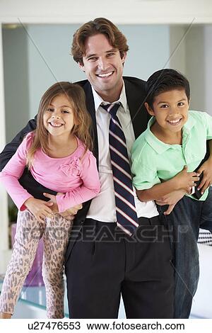 Stock Image - Children Greeting Father On Return From Work. Fotosearch