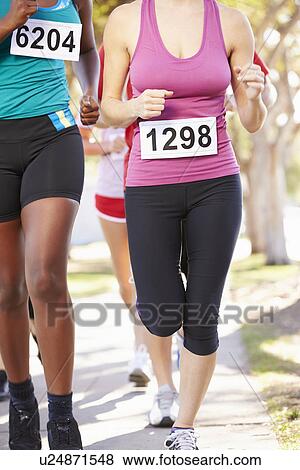 Stock Photo - Close Up Of Female Runners In Race. Fotosearch